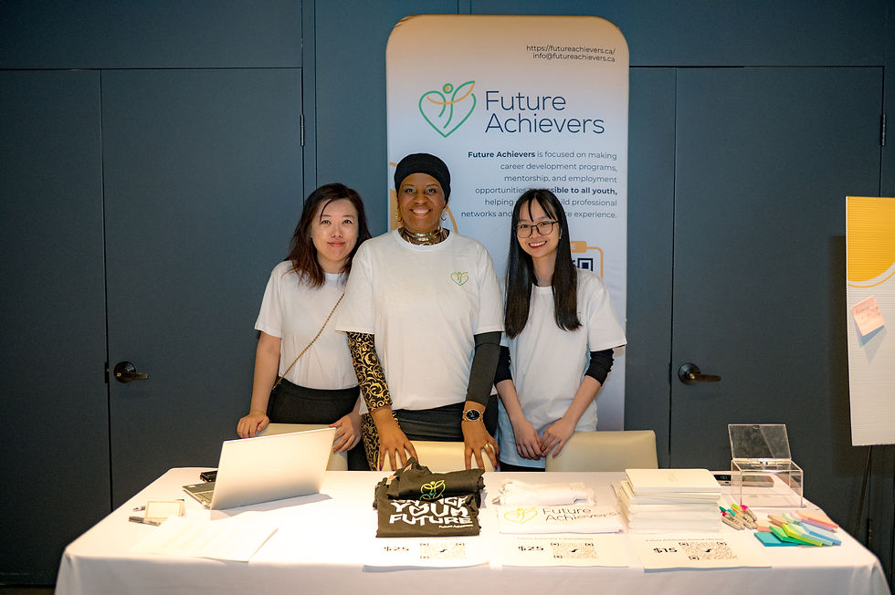 Three people stand behind a table with Future Achievers logo and text.