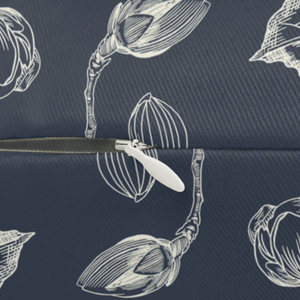 A rectangular reversible charcoal cushion displaying a detailed white botanical sketch on one side and off-white vertical str