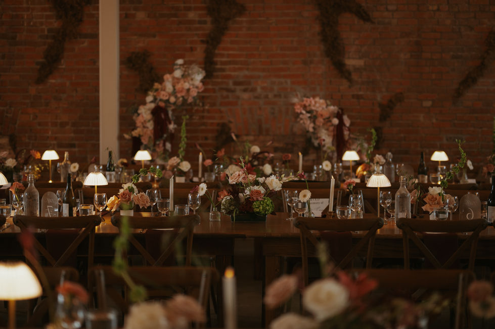 Warm romantic wedding reception with table lamps and florals at the Pendennis Building Edmonton.