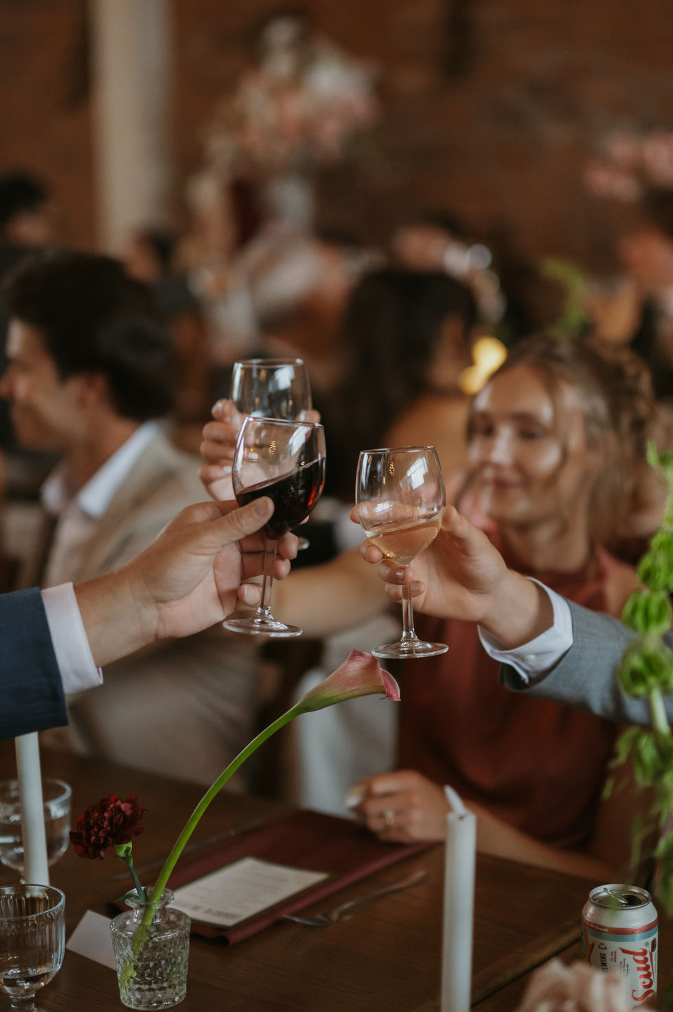 Wedding guests sharing a toast during a Pendennis Building reception in Edmonton.