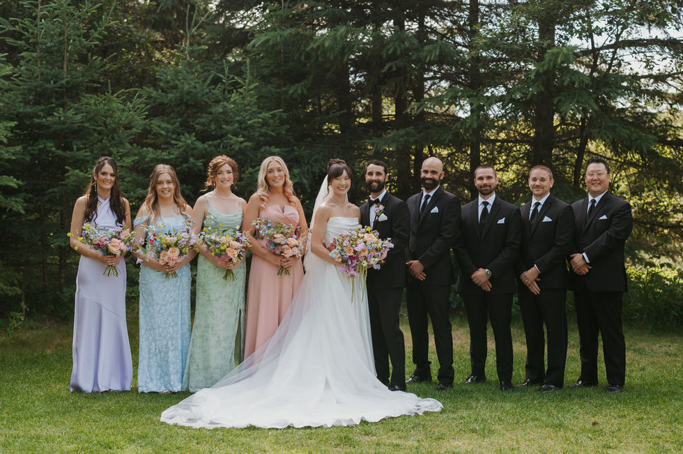 Bride, groom and wedding party with pastel dresses and colourful bouquets at The Valley.