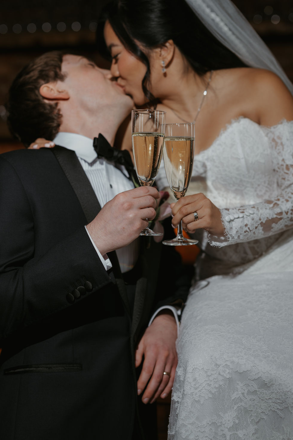 Bride and groom sharing a champagne toast at the Pendennis Building in Edmonton.