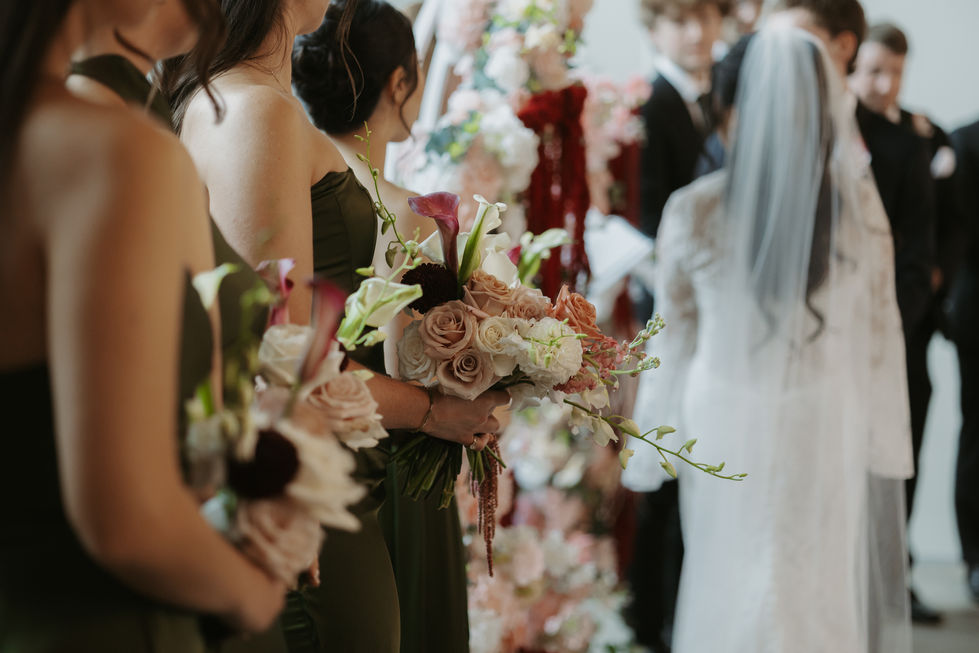 Olive green bridesmaid dress with peach and cream wedding flowers at the Pendennis Building.