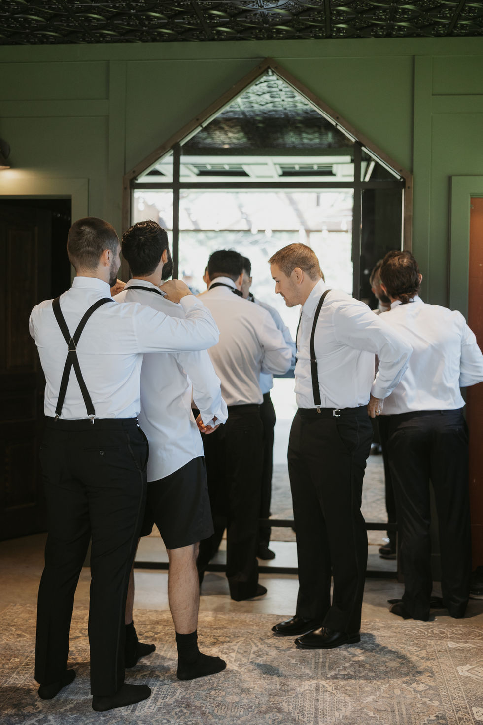 Groom and groomsmen getting ready together before a summer wedding at The Valley.