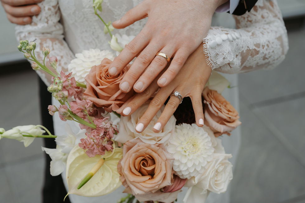 Bride holding a romantic peach and cream floral bouquet before her Edmonton wedding ceremony.