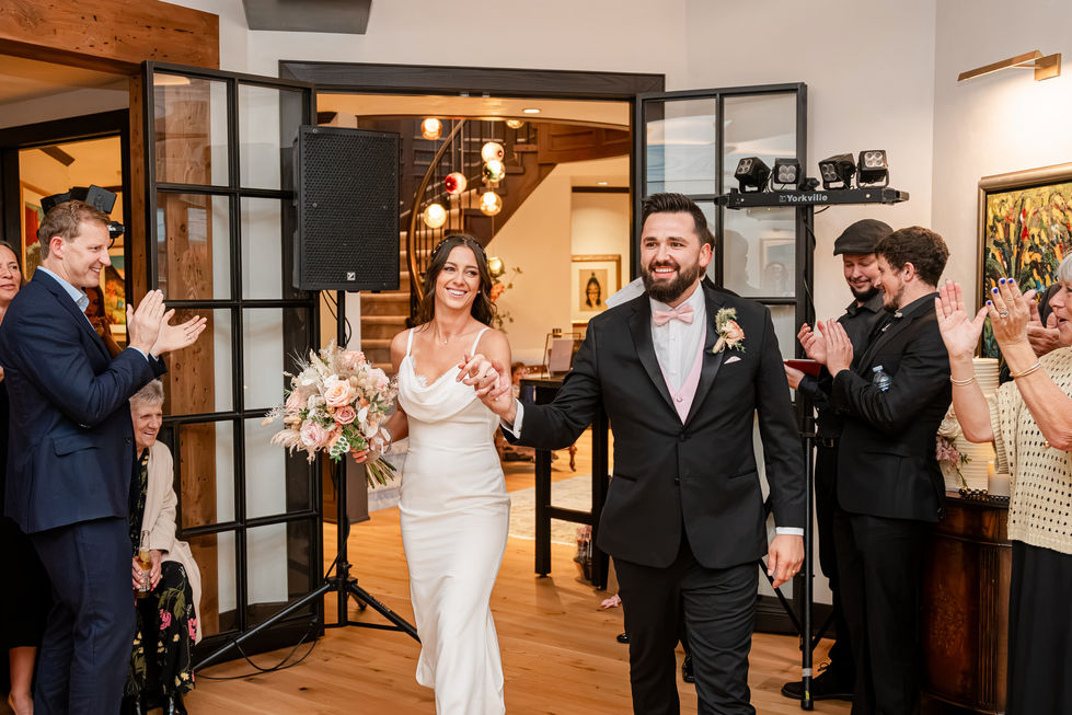 Bride and groom entering their intimate private-property wedding reception in Edmonton.