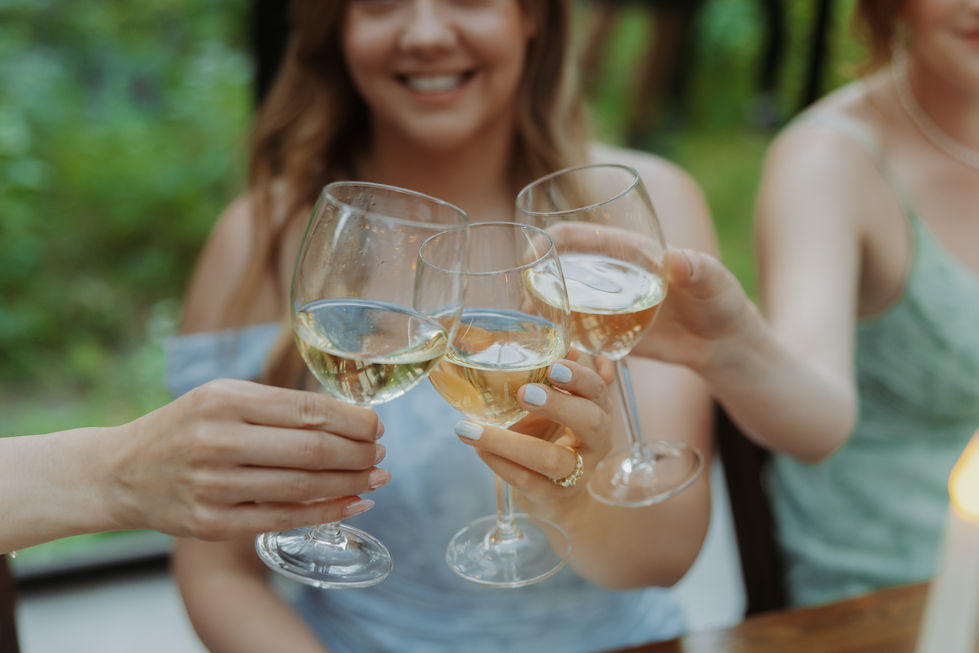 Wedding guests clinking wine glasses during a reception toast at The Valley.