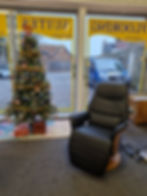 Clearance sale black leather swivel electric recliner with christmas tree in background