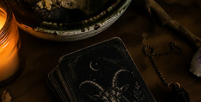 Tarot deck, pendulum, and divination tools displayed for intuitive readings at Haus ov Ashe.