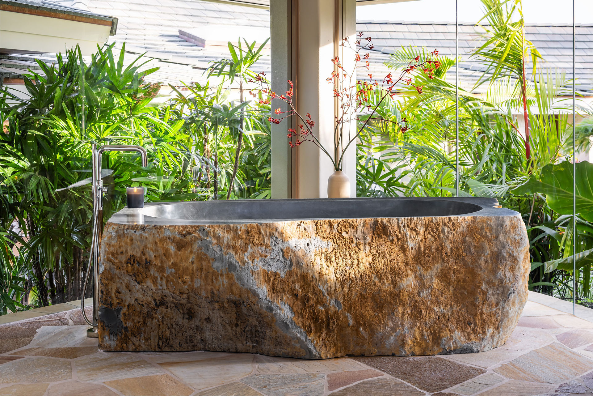 Luxury Hawaiian bathroom with stone soaking tub and plaster walls