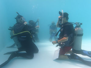 IDC students practicing teaching presentations underwater