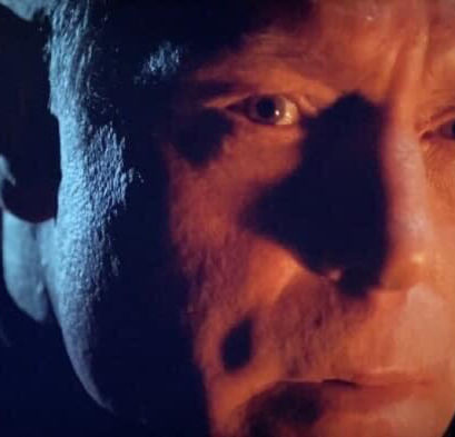 Hank Voight, enveloped in shadows, reflecting the intense and brooding atmosphere typical of "Chicago PD."