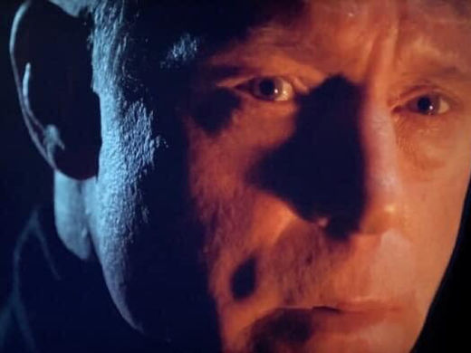 Hank Voight, enveloped in shadows, reflecting the intense and brooding atmosphere typical of "Chicago PD."