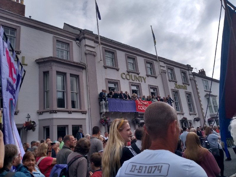 County Marriott hotel with people on the balcony and more people marching past.