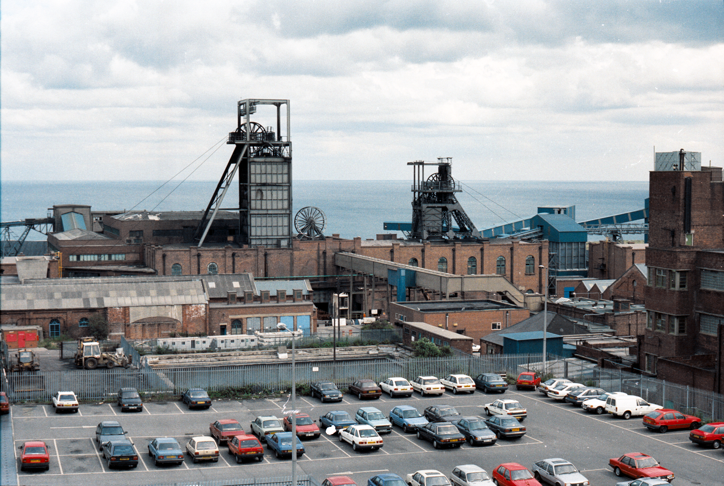 Colour image of Easington colliery with car park in the foreground and the North sea in teh background