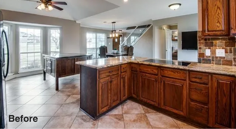 Before photo of kitchen with dated wood cabinets and existing tile flooring