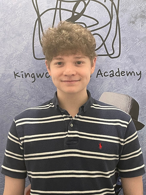 Teacher Ty B. in striped polo at Kingwood Arts Academy, Houston TX.