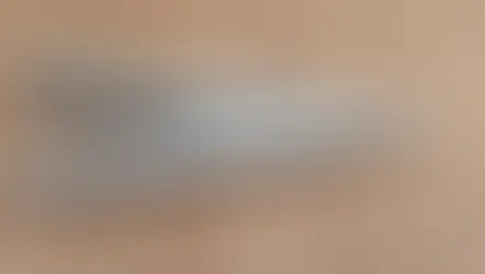 Silver Leatherman multi-tool with pliers on a wood surface. Engraved "LEATHERMAN WAVE" visible. Simple, functional design.