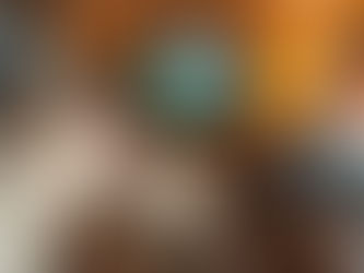 Boy in a cosy caravan watches a nature scene on TV. Teddy bears on cabinet, lamp lit, curtains drawn. Warm lighting and decor create a relaxed mood.