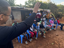 Anthony Woodland, missionary of Ahmadi Religion of Peace and Light, serves hot meals to 38 orphans at Jesus’ Helpers Children Home in Deep Sea slum, Nairobi, Kenya, while distributing “God is Calling You” flyers.