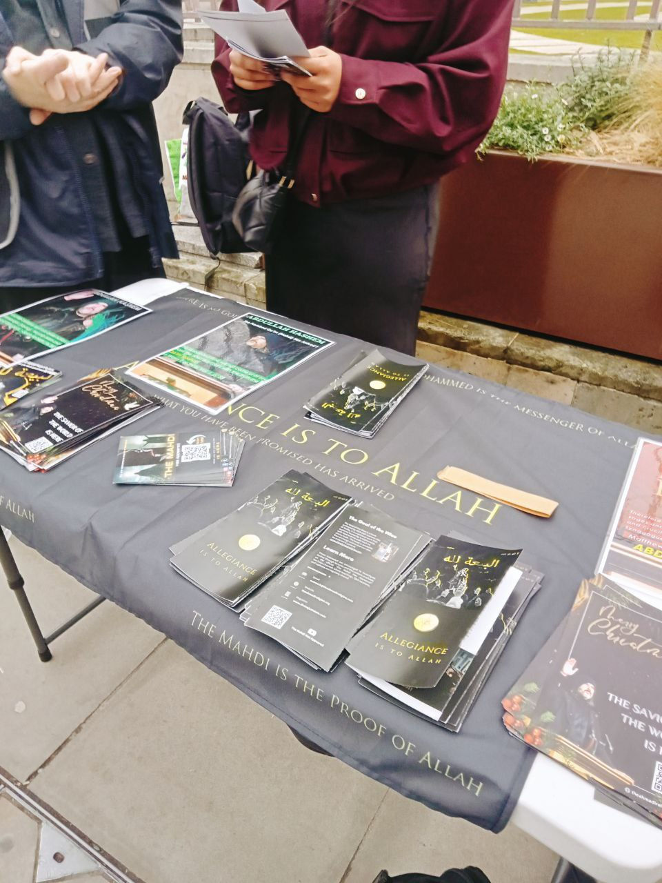 Participants use a megaphone to address crowds on wealth injustice and the need for divinely appointed leadership in central London.
