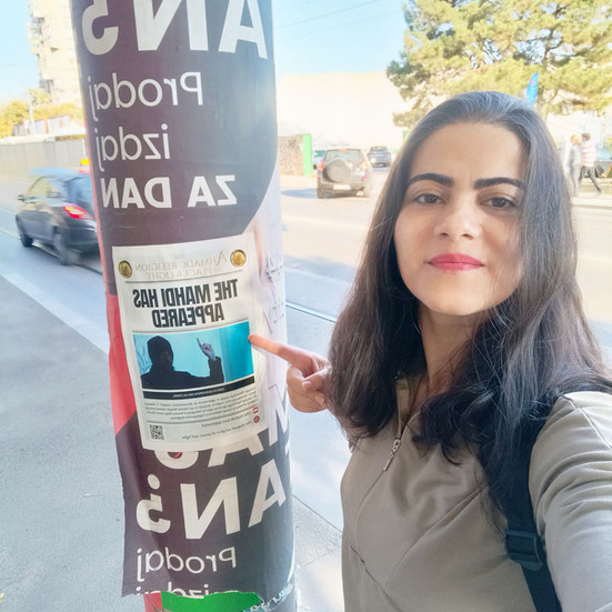 a woman spreads AROPL flyers in Serbia