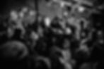 Abdullah Hashem raises his hand in a crowd of believers