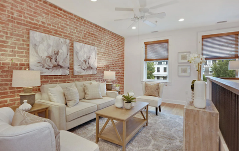 Charming accents such as an exposed brick wall adorn this Petworth home