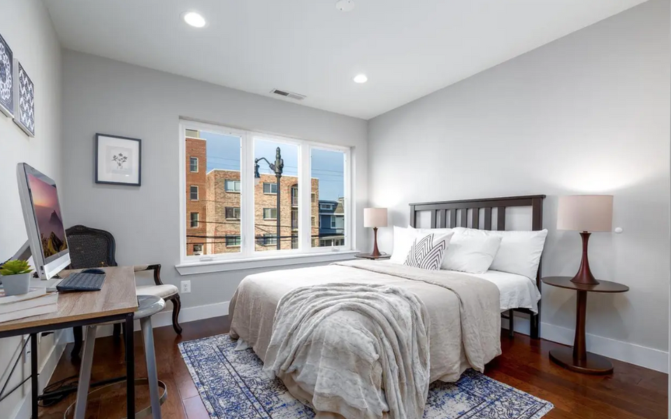 A large bedroom with lots of natural light located in a Washington DC rental property