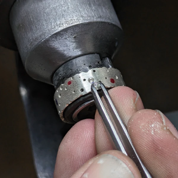 Silver ring making process - setting diamonds on a silver ring - diamond setter