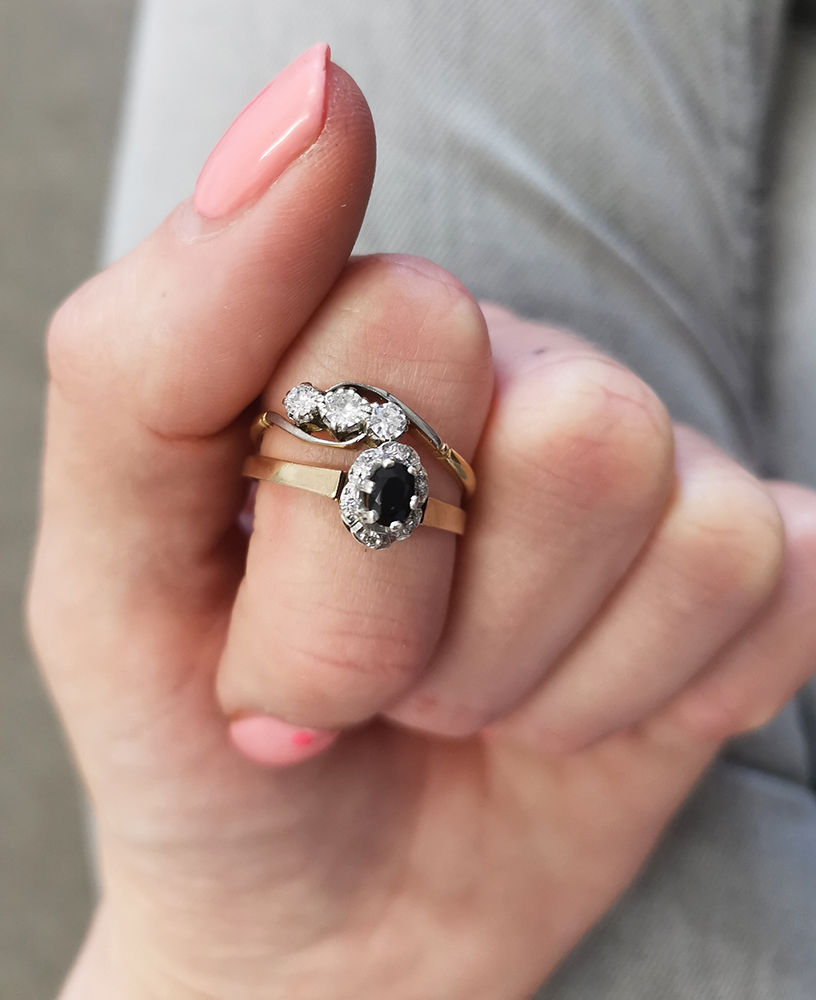 Two rings worn on a woman's hand ready to enter the jewellery remodelling process and be turned into one new ring