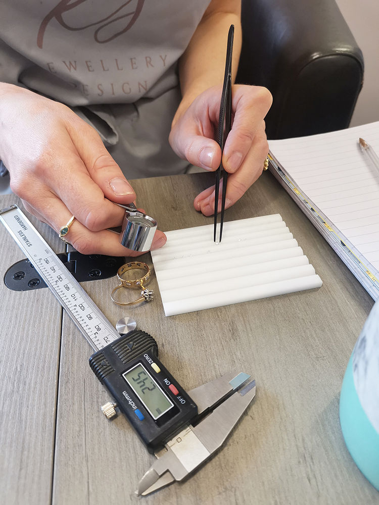 Contemporary jewellery Kate Smith measuring gems for a remodelling project