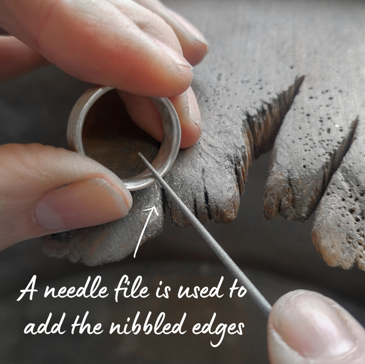 Using a needle file to add nibbled edges to a silver ring
