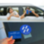 Couple showing the HAUP app and Temporary Card from inside a white rental car, demonstrating easy car access and app-based car rental in Thailand