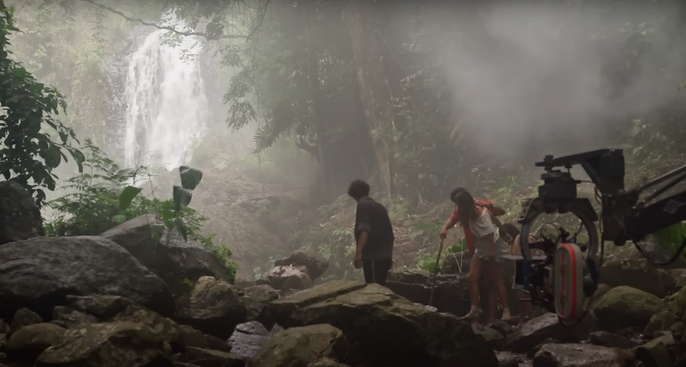 เบื้องหลังการถ่ายทำภาพยนตร์ Jurassic World: Rebirth ที่น้ำตกห้วยโต้ จังหวัดกระบี่ ทีมงานและนักแสดงเตรียมฉากกลางป่าฝน รายล้อมด้วยหมอก หิน และพรรณไม้เขตร้อนใกล้น้ำตกที่ไหลลดหลั่น