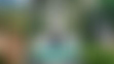 Couple enjoying a road trip in Khao Yai, Thailand, standing beside a white car with scenic views of Toscana Valley, forest roads, and waterfalls