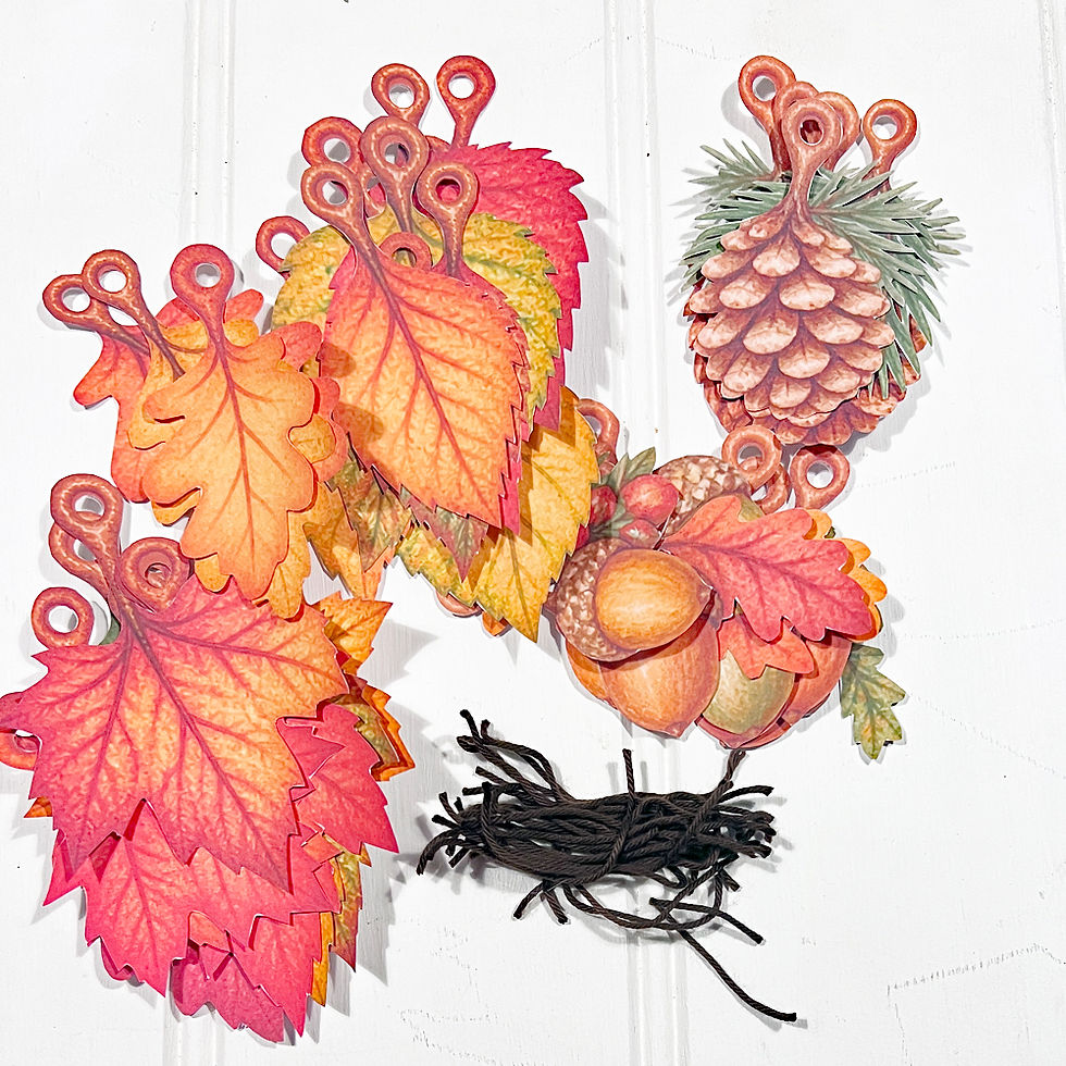 Picture of finished cut out elements with pile of short strings to attach them