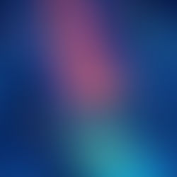 Abstract image of mountains around an ocean. The image is in shades of dark and light blue, and cosmic purples and pinks. There are lighter rings around the rocks in the water depicting light shining on them