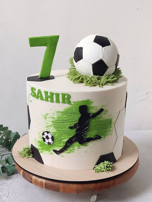 Soccer-themed birthday cake with the number 7, Sahir, and soccer ball details.