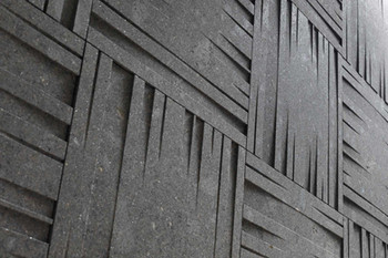 Close-up of charcoal 3D stone tiles with intersecting raised strips