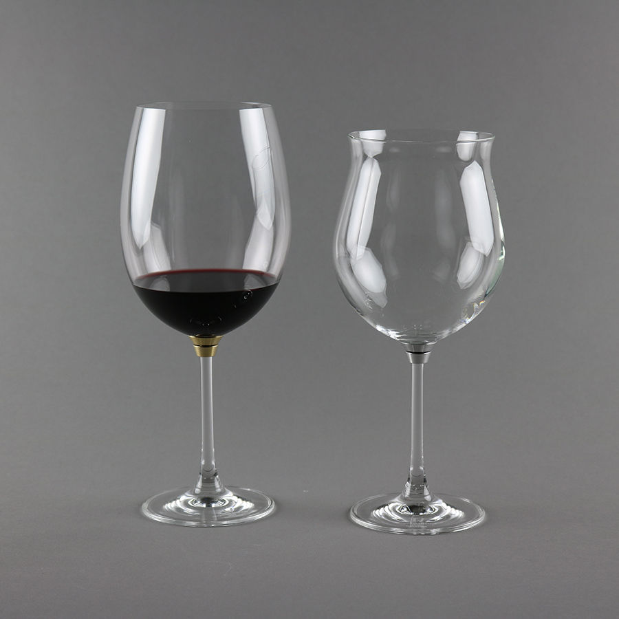 Pair of Vortice Platinum crystal rotating wine glasses with closed bowls staged on a dining table