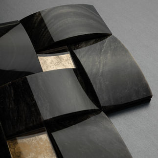 gant obsidian stone panels with silver reflections and artisanal aged glass.