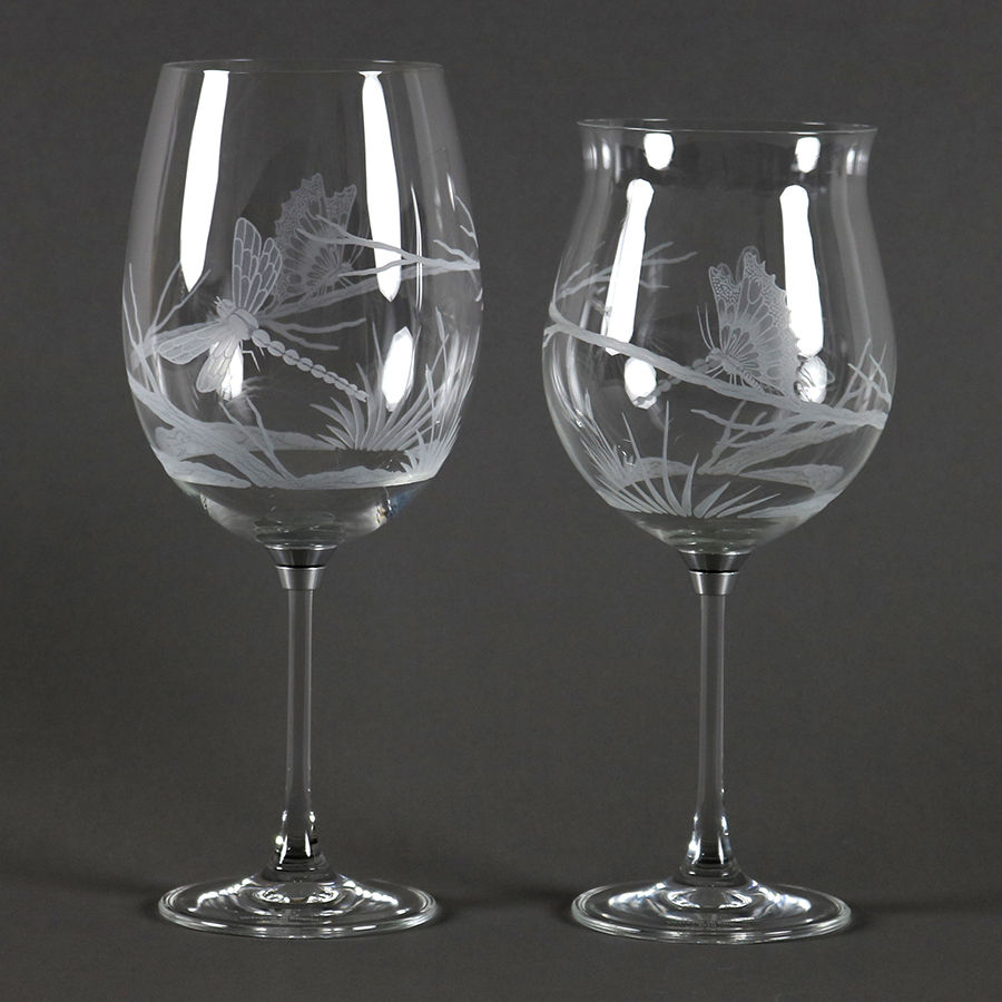 Set of Vortice Platinum hand-engraved crystal spinning wine glasses showing open and closed bowl shapes.