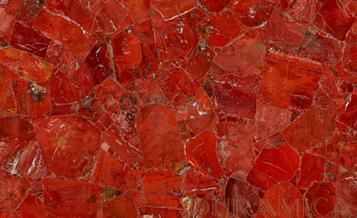 I pannelli Duramica GemStone celebrano la bellezza delle pietre semipreziose naturali, con particolare attenzione ai toni profondi e terrosi del diaspro rosso. Ogni pannello è meticolosamente realizzato a mano e presenta pietre sapientemente tagliate e lucidate, montate su una base di pannello DuraSkin in ceramica, pannello in magnesio e pannello Duramet in alluminio a nido d'ape. Questa costruzione innovativa migliora sia la profondità visiva che la durata strutturale, offrendo pannelli di grande formato che conferiscono una raffinatezza senza tempo a qualsiasi spazio. I pannelli Duramica GemStone offrono una selezione mozzafiato di design di grande formato, realizzati con il più pregiato diaspro rosso e sostenuti da una resistente base in materiale composito. Ogni pannello in diaspro rosso è una dichiarazione d'arte, che fonde il fascino naturale di questa antica pietra preziosa con l'innovazione dei materiali all'avanguardia.