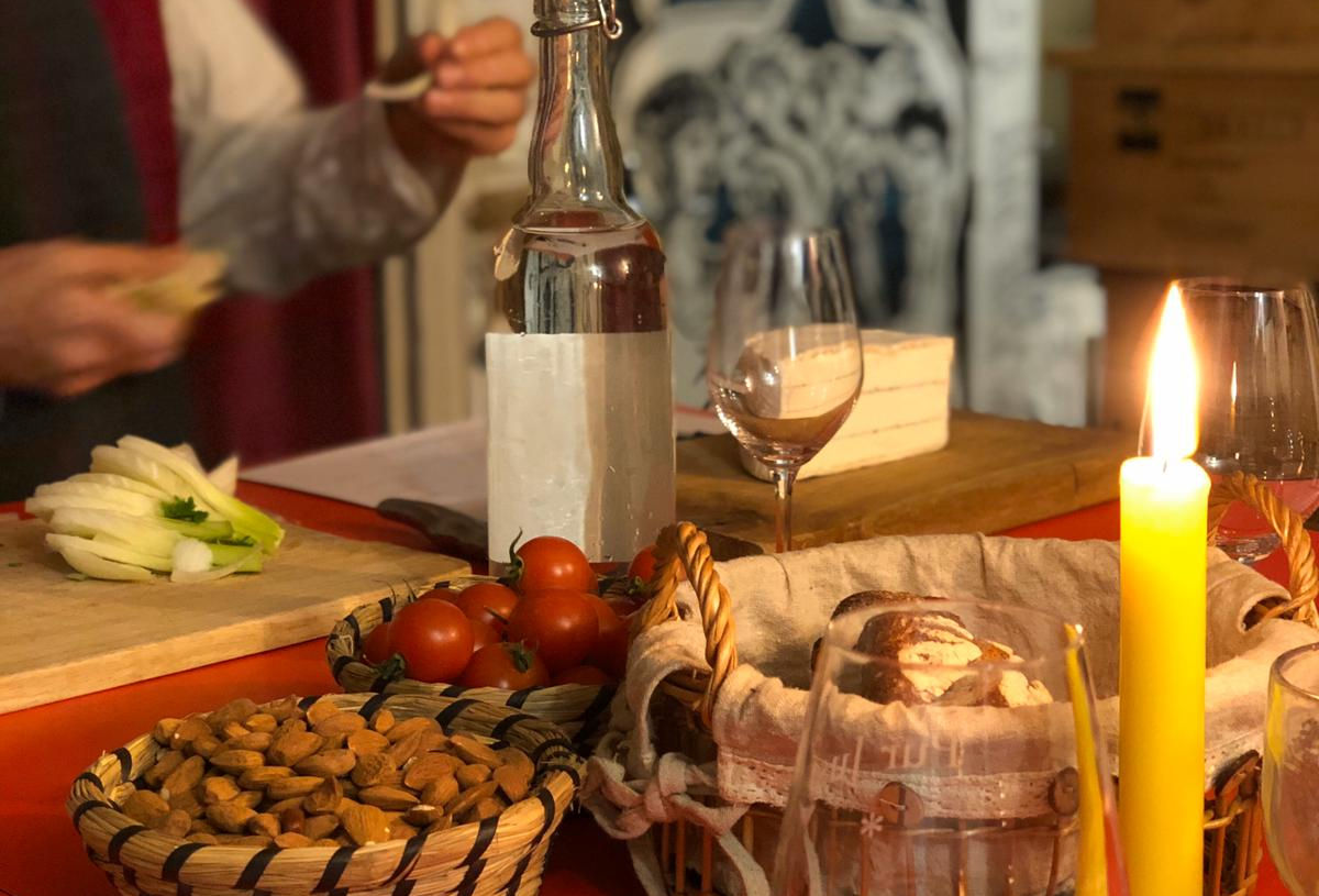 A table set for a wine tasting with cheese and candles.