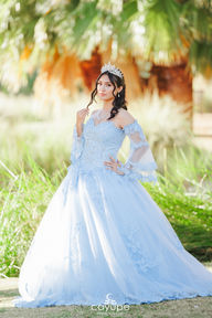Dezeray spinning in her blue dress, with the sun and nature at Agua Caliente Park framing the scene.