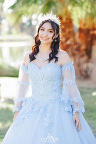 Dezeray with a radiant smile under the sunlight, showing the sparkling details of her dress.