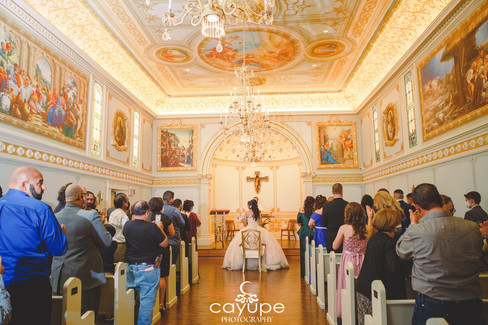 Back view of Our Lady’s Chapel during the Quinceañera mass, showcasing its ornate ceilings and golden details.