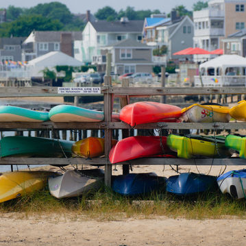 Colorful kayaks, stored on racks outside in Provincetown, MA