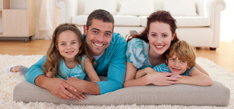 Happy Family Hugging and Smiling Together